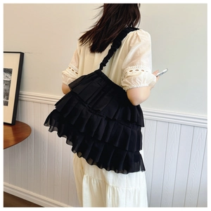 Detailed back view of a black tiered ruffled chiffon tote bag with ruched shoulder strap