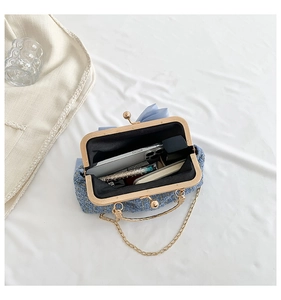 Internal view of tweed bag showing space for a smartphone and makeup essentials