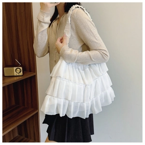Detail of white ruffled layered lace tote bag with pleated straps for sweet aesthetic