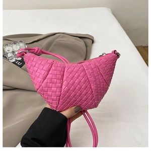 Detail of rose pink hand-woven dumpling bag with knotted handle and silver zipper