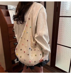 Detail of cream crochet shoulder bag featuring vibrant multi-colored faux pearl beads