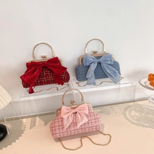 Elegant tweed evening clutch bags with oversized bows in red, blue, and pink colors