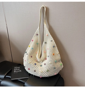 Detail of hand-woven off-white mesh hobo bag decorated with vibrant colorful pearls