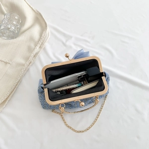 Blue tweed evening bag with pearl clasp and gold chain showing interior capacity