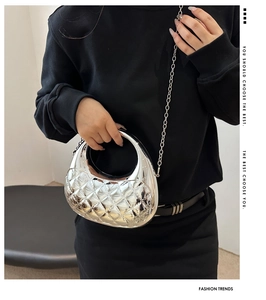 Close-up of silver quilted acrylic bag with metallic mirror finish and chain strap