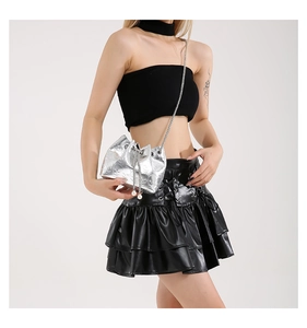 Detail of silver bucket bag with skull embossing, chain strap and pearl drawstring