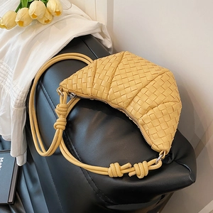 Handwoven yellow crescent crossbody bag with intrecciato texture and knot strap detail