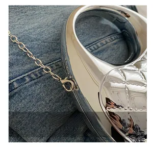 Detail of silver metallic heart bag showing the lobster clasp and chain link hardware