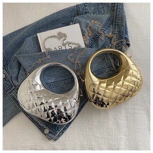 Detail of metallic semi-circle handbags with quilted diamond patterns and chain straps