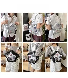 Detail of star-shaped ita bag featuring a clear window for displaying anime badges