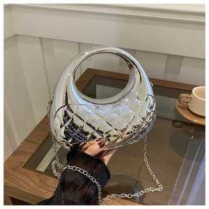 Silver quilted metallic finish handbag with chain strap shown in a modern interior setting