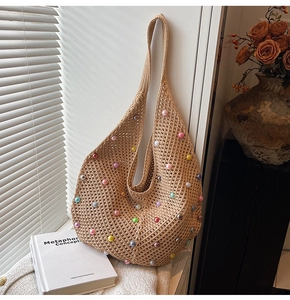 Detail shot of handwoven knit bag with colorful pearl beads and bohemian texture design
