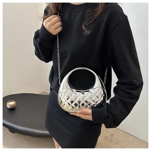 Detail of silver mirror acrylic crescent bag with quilted pattern and metal chain