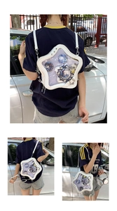 Star-shaped white Ita bag showing shoulder and crossbody wear with badge display