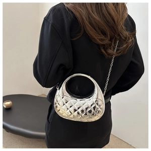 Close-up of a metallic silver quilted crossbody bag with a sleek chain strap