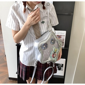Bolso Ita plateado en forma de estrella con ventana transparente y pines en el hombro