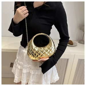 Chic gold acrylic evening bag with quilted pattern and round top handle on a model
