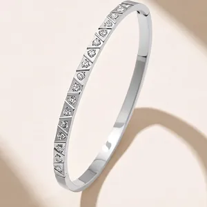 Polished silver stainless steel bangle with pavé-set round rhinestones for women