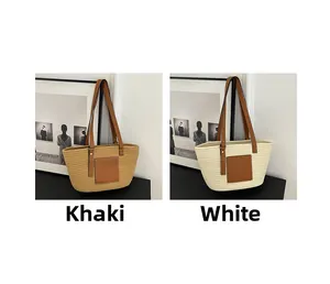 Detail of khaki and white woven straw tote bags with brown leather handles and square patches
