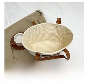 Top view of cream woven tote bag showing spacious interior and brown leather straps