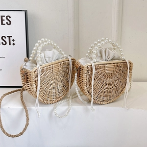 Handmade woven bamboo handbag with pearl handle and detachable crossbody chain