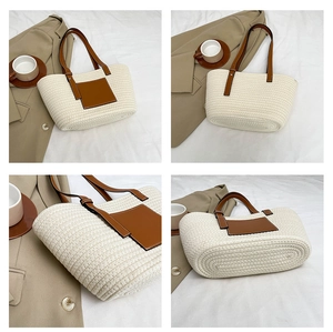 Detail view of woven tote bag with brown leather handles and sturdy base design
