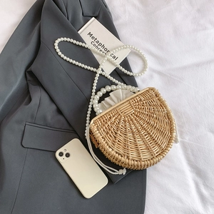 Handmade woven bamboo straw bag with pearl strap and drawstring inner lining