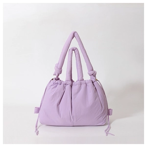 Lilac padded nylon puffer tote bag with adjustable drawstring sides and knotted handles