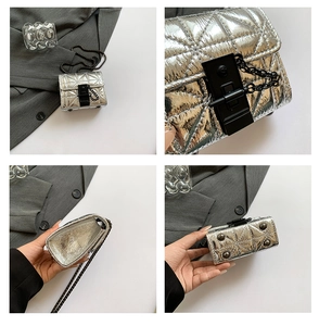 Detail view of silver quilted crossbody bag with metal chain strap and interior space