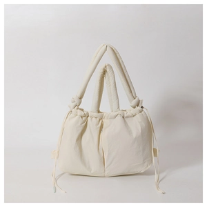 Puffy cream white nylon tote bag with drawstring details and padded shoulder straps