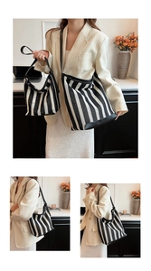 Detail view of large and small striped tote bags with black leather trim and woven texture