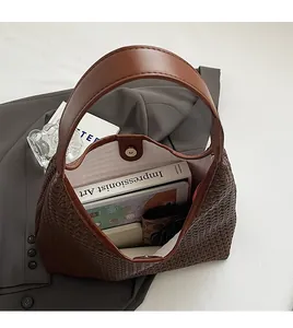 Top-down view of a spacious brown woven leather tote bag showing large storage capacity