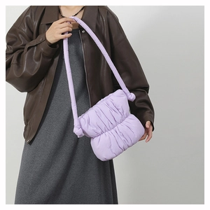 Detailed view of light purple cloud bag featuring soft quilted texture on model shoulder
