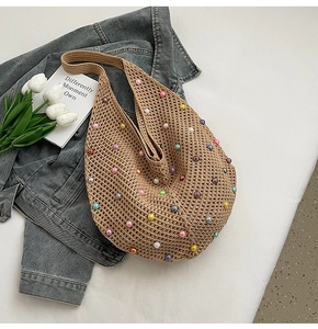 Close-up of handmade crochet tote bag with colorful pearls and hollow weave texture