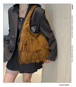 Brown suede tassel shoulder bag with three-layer fringe design on fashion model