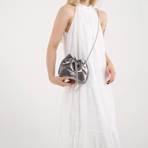 Silver skull embossed drawstring bucket bag with chain strap and pearl accents