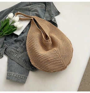 Close-up of pearl-studded crochet net bag with natural woven texture for summer beach use