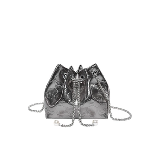 Silver metallic drawstring bucket bag with embossed skulls and pearl chain strap