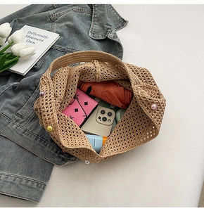Detail of crochet tote bag interior showing capacity for umbrella, phone, and makeup
