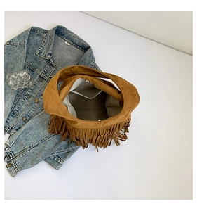 Close-up of the interior pocket and high-quality suede fringes on a brown tote bag