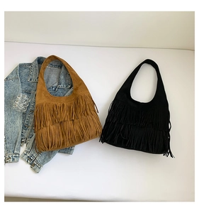 Detail view of vintage boho hobo bags with long tassels in brown and black suede finish