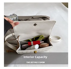 Detail view of the white woven handbag interior showing large storage capacity