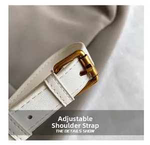 Detail of adjustable off-white crossbody strap with premium cross-grain texture and gold buckle