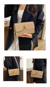 Detail of hand-woven beige leather crossbody bag with elegant gold knot metal lock closure
