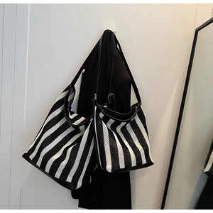 Detail of black and white striped mesh tote bags in large and small sizes with leather straps