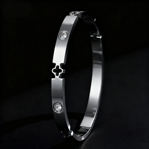 Polished silver stainless steel bangle with mother-of-pearl floral pattern and diamonds