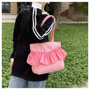 Detailed view of pink canvas tote bag featuring stylish ruffled pleated decoration
