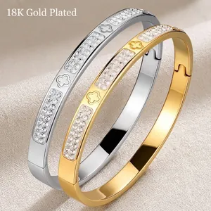 18K plated stainless steel clover bangle set with double rows of pavé zircons in gold and silver