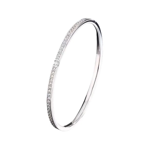 Close-up of a minimalist silver titanium steel bangle with shimmering micro-pave crystals