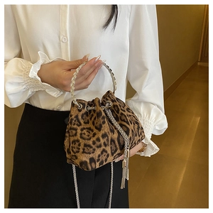 Detail of leopard print bucket bag with metal ring handle and chain drawstring tassel